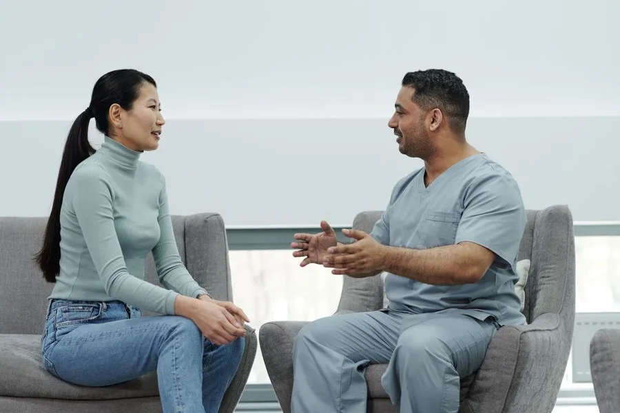 A patient talking with a healthcare provider during a consultation