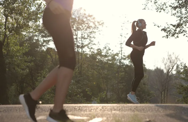 Women walking outdoors in a sunny park for morning exercise